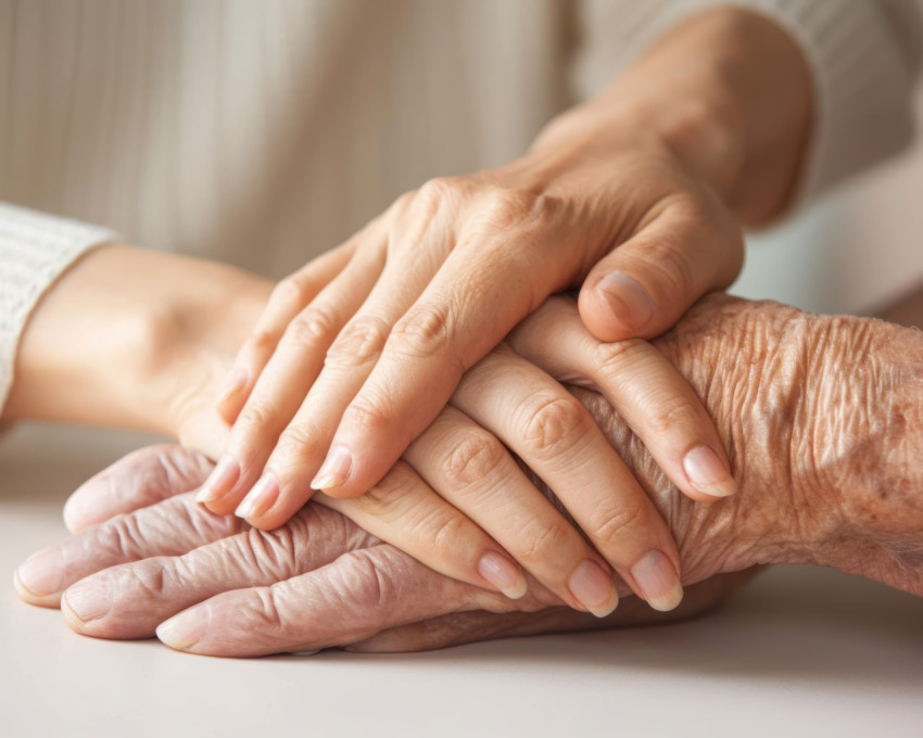 Mature wife or carer holding aged husband hands expressing care and support Mature wife or carer holding aged husband hands expressing care and support
