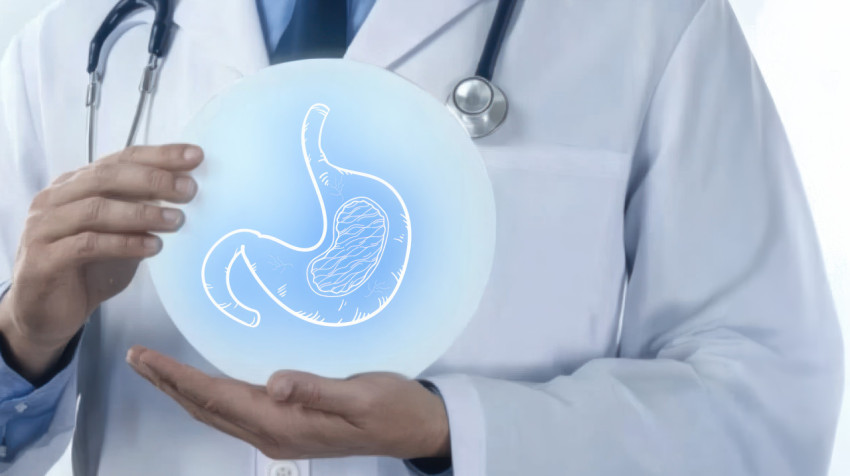 Doctor holding an icon representing the stomach discussing acid reflux