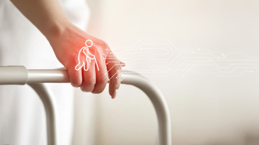 A close up of a nurse holding an elderly person hand on a walker A close up of a nurse holding an elderly person hand on a walker