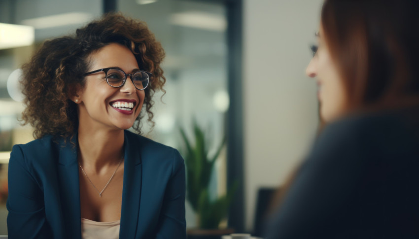 Two women wearing glasses are busy discussing work and exchanging ideas in a friendly atmosphere Two women wearing glasses are busy discussing work and exchanging ideas in a friendly atmosphere