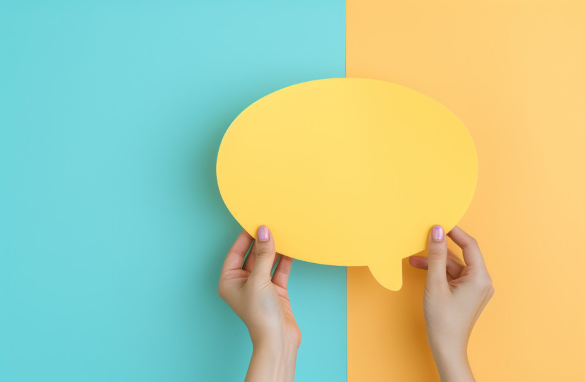 Two hands showcase a yellow speech bubble ready for your messages Two hands showcase a yellow speech bubble ready for your messages