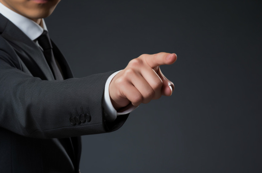 A business man in a suit pointing to something on a gray background, seo stock images for marketing campaigns A business man in a suit pointing to something on a gray background, seo stock images for marketing campaigns