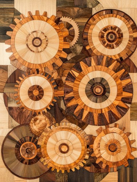 Interlocking gears crafted with precise marquetry wood inlays Interlocking gears crafted with precise marquetry wood inlays