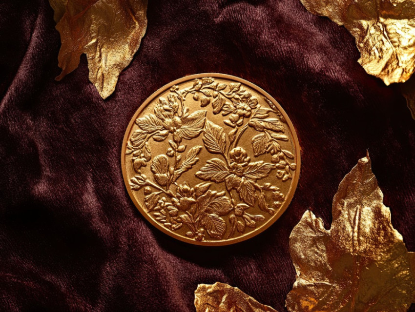 Ornate coin with embossed filigree Ornate coin with embossed filigree