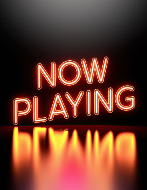 Neon glow typography "Now Playing" in orange vintage bold font Neon glow typography "Now Playing" in orange vintage bold font