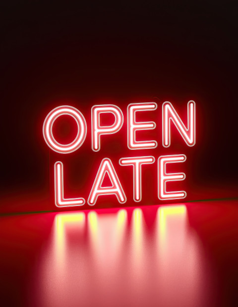 Neon glow typography "Open Late" in vivid red neon with retro font on black Neon glow typography "Open Late" in vivid red neon with retro font on black